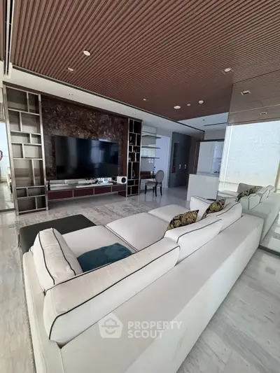 Luxurious modern living room with elegant white sofa and large TV setup