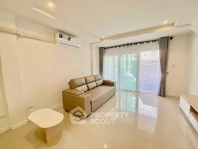 Spacious modern living room with large windows and elegant furnishings