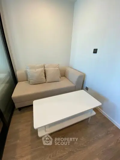 Modern living room with sleek furniture and wooden flooring