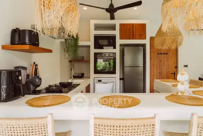 Chic modern kitchen with open layout, featuring stylish appliances and natural decor elements.