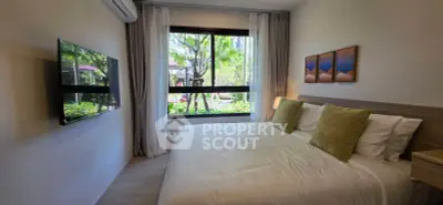 Modern bedroom with large window and garden view, featuring a wall-mounted TV and stylish decor.