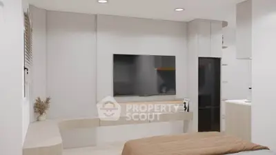 Modern bedroom with sleek TV setup and minimalist decor