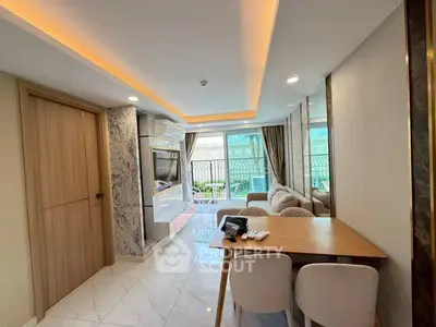 Modern living room with elegant marble accents and cozy seating area