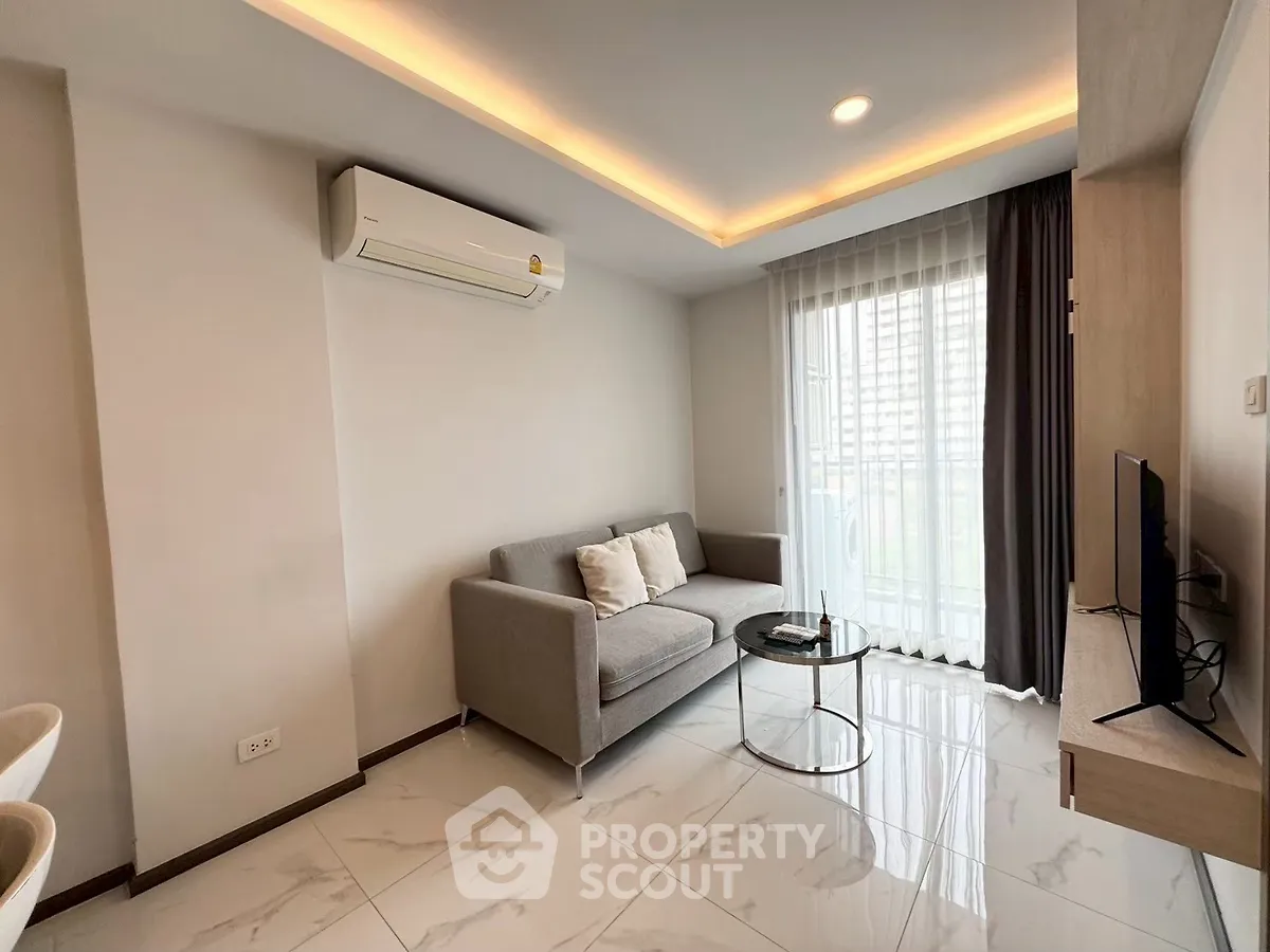 Modern living room with sleek design, featuring a cozy sofa, flat-screen TV, and large window with city view.