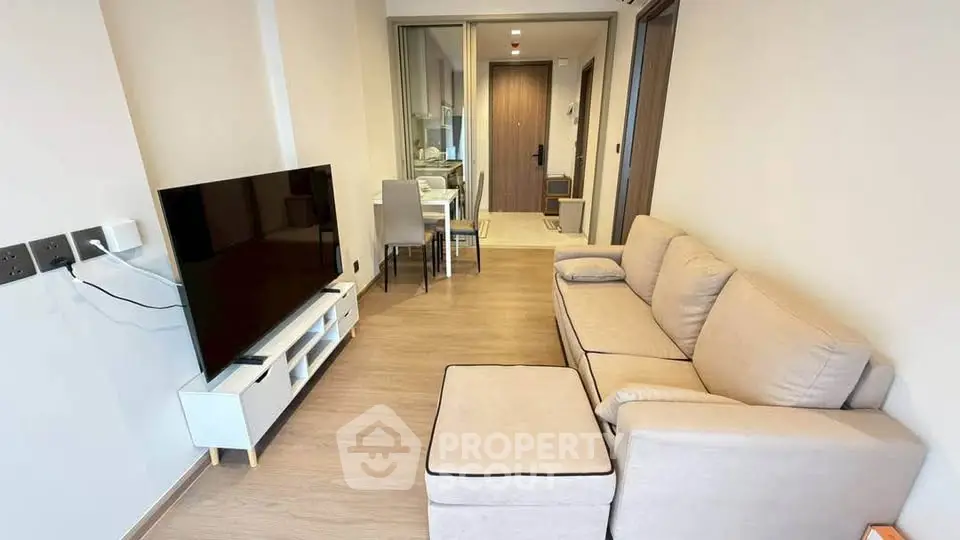 Modern living room with cozy sofa and large TV in stylish apartment