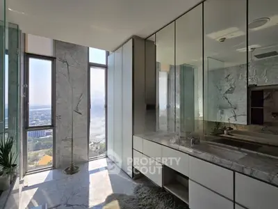 Luxurious bathroom with stunning city view and elegant marble finishes