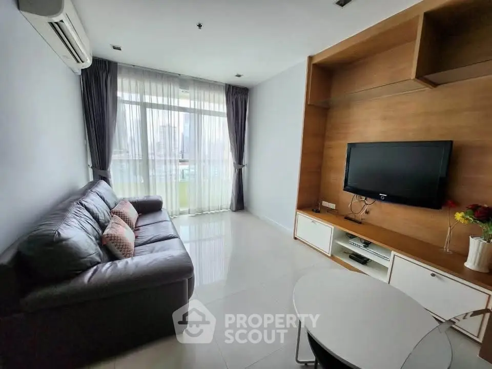 Modern living room with sleek furniture and city view, perfect for urban living.