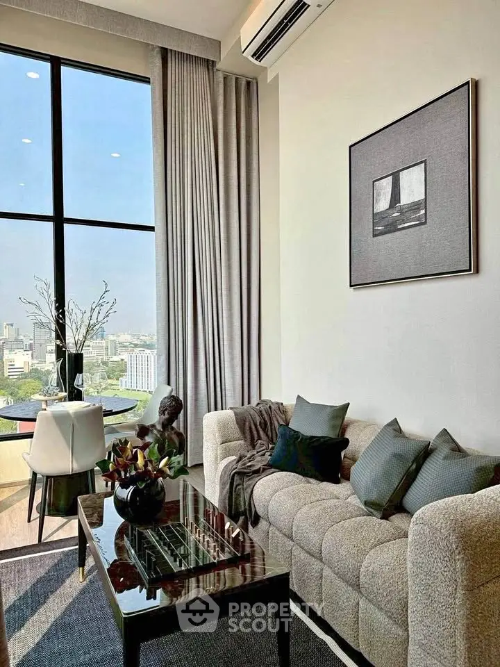 Modern living room with large window and city view, featuring stylish decor and comfortable seating.