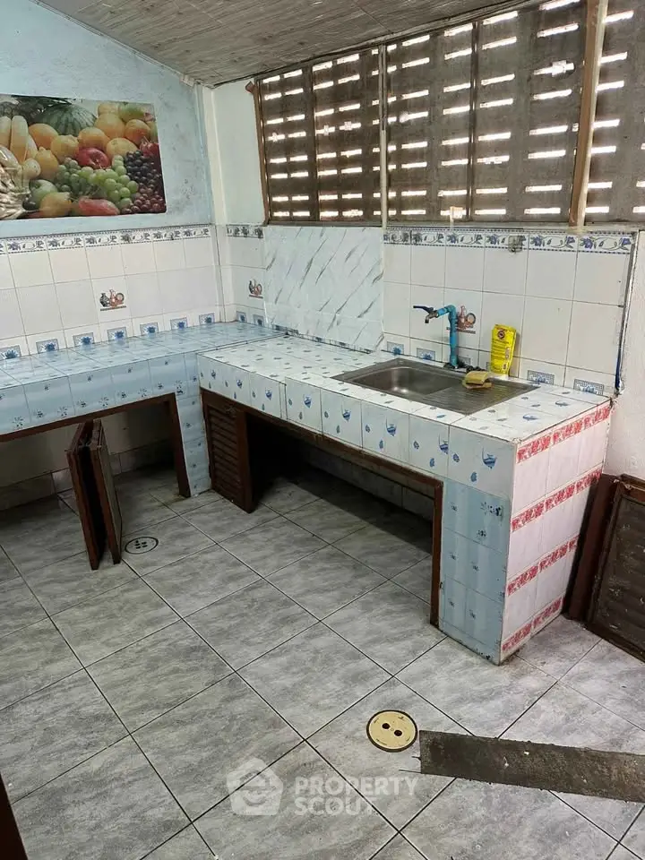 Charming rustic kitchen with tiled countertops and open layout, perfect for culinary creativity.