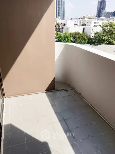 Bright balcony with modern design and city view, perfect for relaxation.