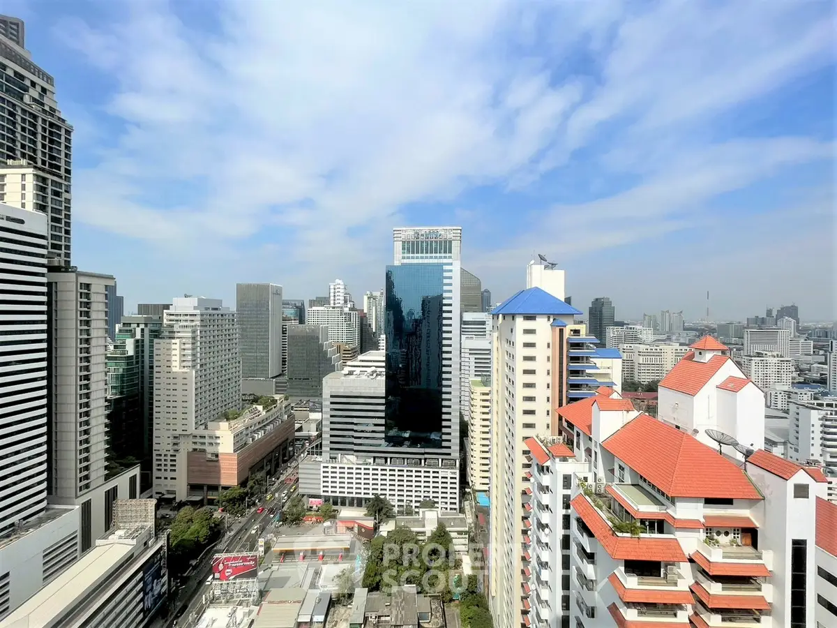 Stunning cityscape view from a high-rise building showcasing urban skyline and vibrant architecture.