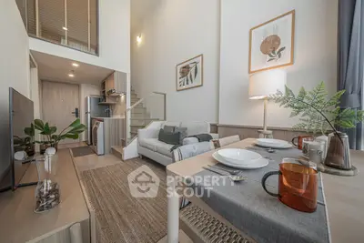 Modern duplex apartment with stylish decor, open living area, and cozy dining space.