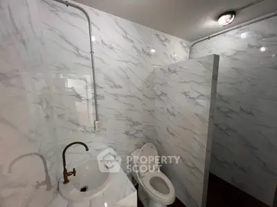 Modern bathroom with marble walls and sleek fixtures