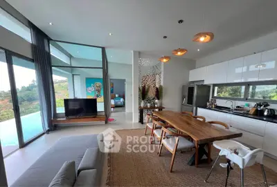 Stunning open-plan living room with pool view and modern kitchen