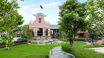 Charming brick house with lush garden and elegant landscaping