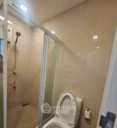 Modern bathroom with glass shower enclosure and sleek fixtures