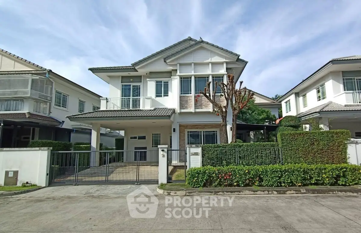 Charming two-story house with manicured garden and spacious driveway in a serene neighborhood.