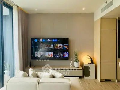 Modern living room with wall-mounted TV and stylish decor in a contemporary apartment.