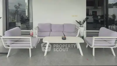 Modern outdoor patio with stylish white furniture and scenic view, perfect for relaxation and entertaining.