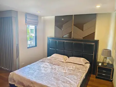 Elegant bedroom with modern decor and large window for natural light