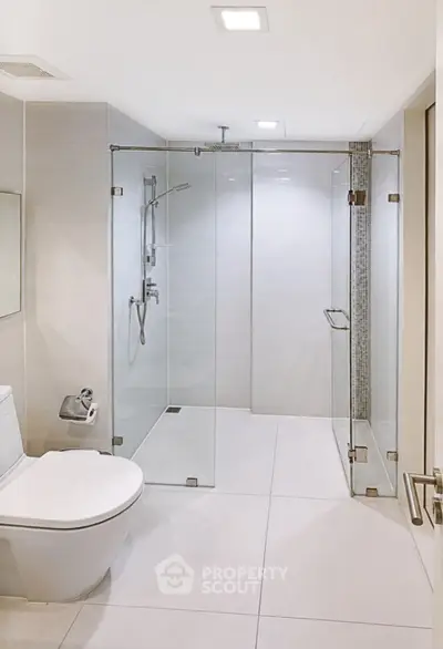Modern bathroom with glass shower enclosure and sleek fixtures