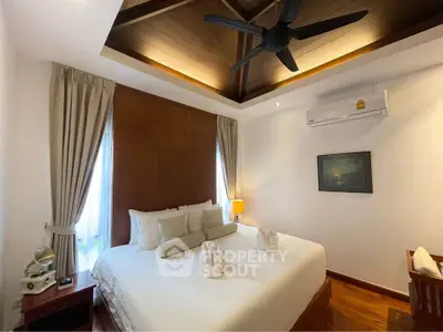 Luxurious bedroom with elegant decor and high ceiling fan, perfect for relaxation.