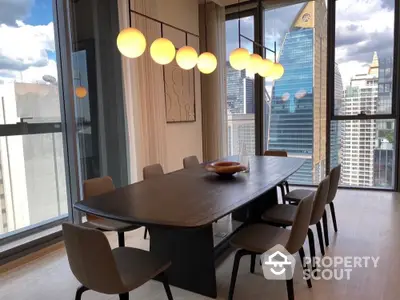 Elegant dining area with city view, modern lighting, and stylish decor in a high-rise apartment.