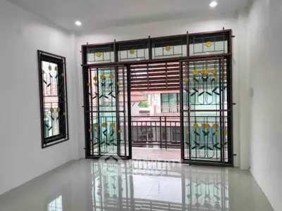 Spacious living room with decorative glass doors and balcony view