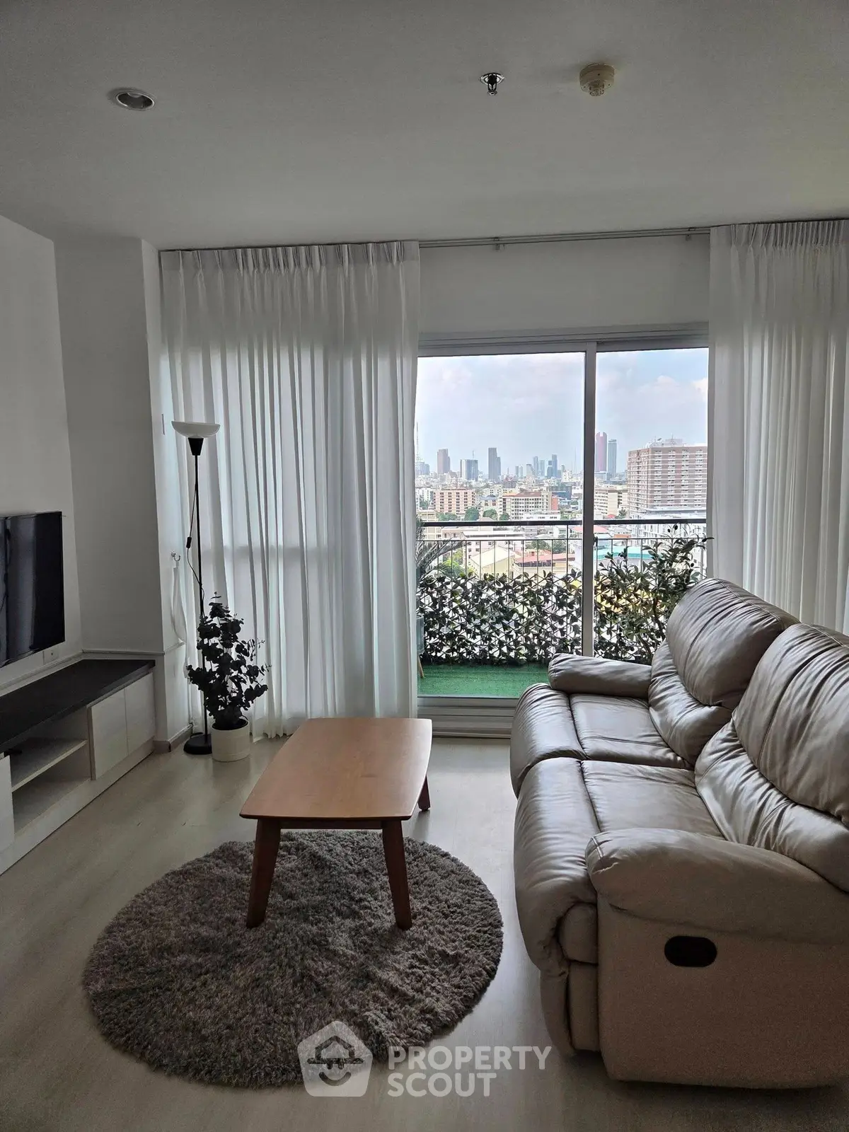 Modern living room with city view and cozy seating area