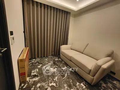 Cozy living room with elegant marble flooring and plush sofa, perfect for relaxation.