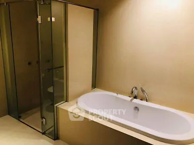 Luxurious bathroom with elegant bathtub and glass-enclosed shower, perfect for relaxation.