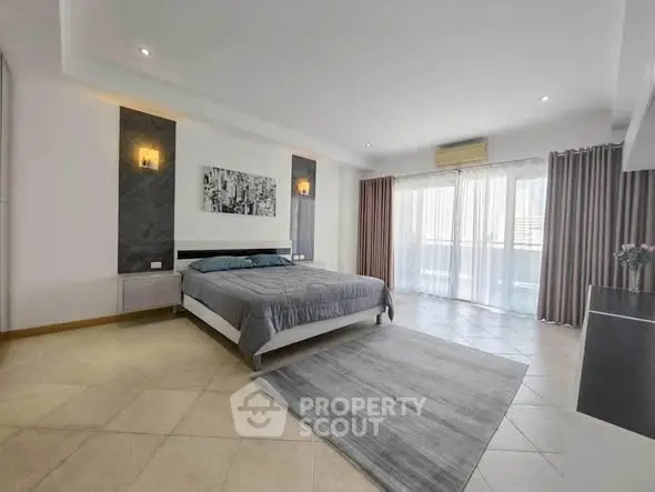 Spacious modern bedroom with large windows and elegant decor