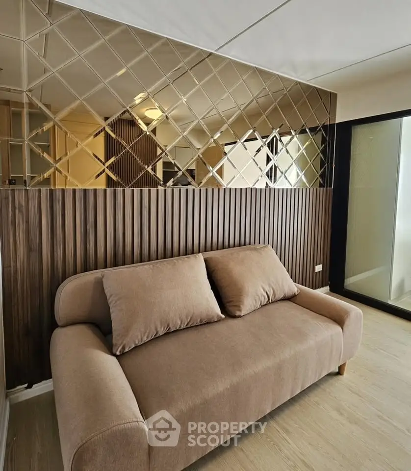 Modern living room with stylish sofa and decorative wall paneling