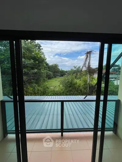 Charming balcony view with lush greenery and open sky, perfect for relaxation and nature lovers.