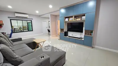 Spacious modern living room with sleek furniture and built-in entertainment center