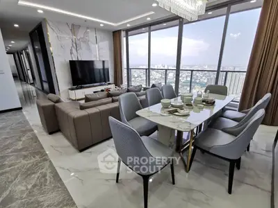 Luxurious high-rise living room with panoramic city views and elegant dining area.