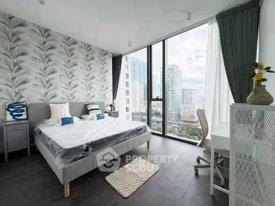 Modern bedroom with floor-to-ceiling windows offering stunning city views, stylish decor, and cozy furnishings.