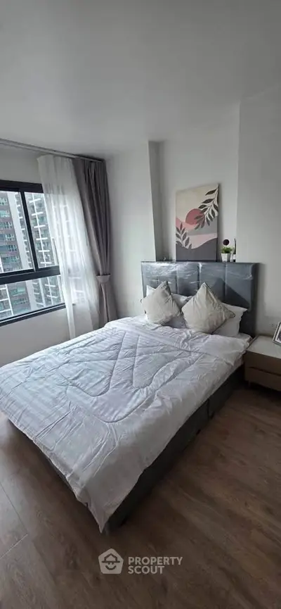 Modern bedroom with large window and stylish decor in urban apartment