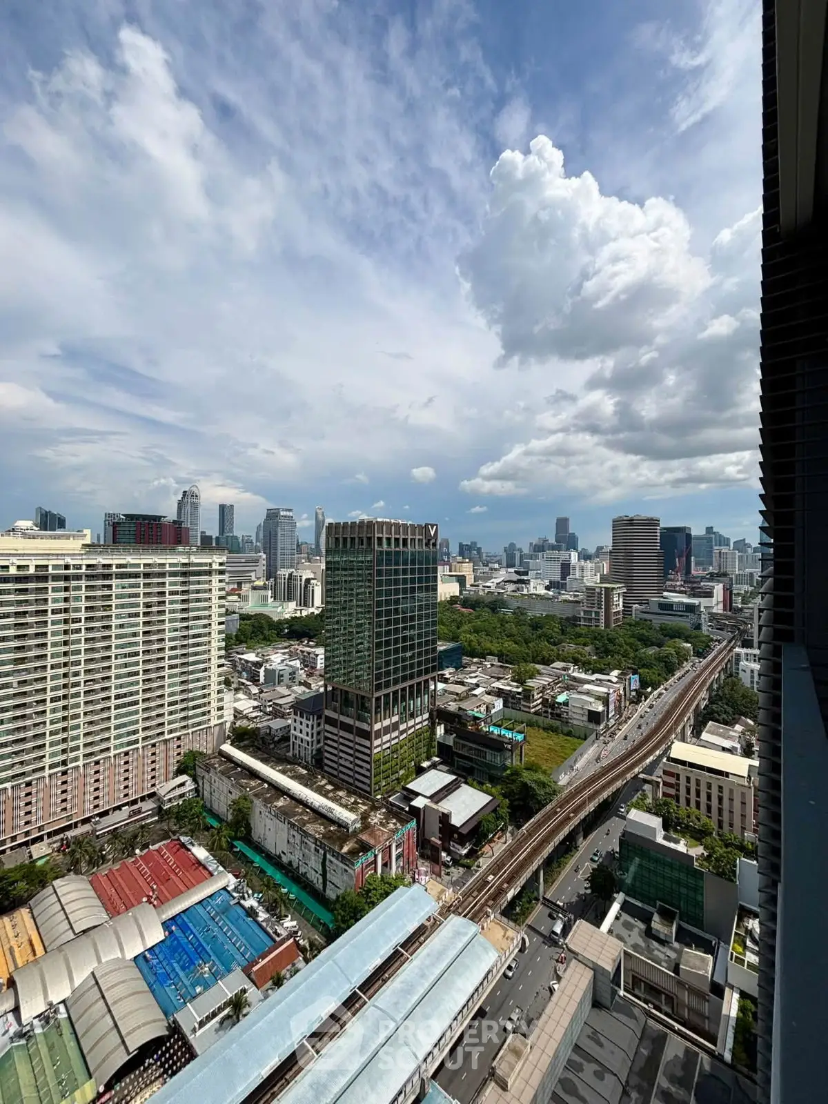 Stunning cityscape view from high-rise building showcasing urban skyline and vibrant city life.