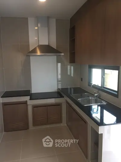 Modern kitchen with sleek cabinetry and built-in appliances in a stylish apartment.