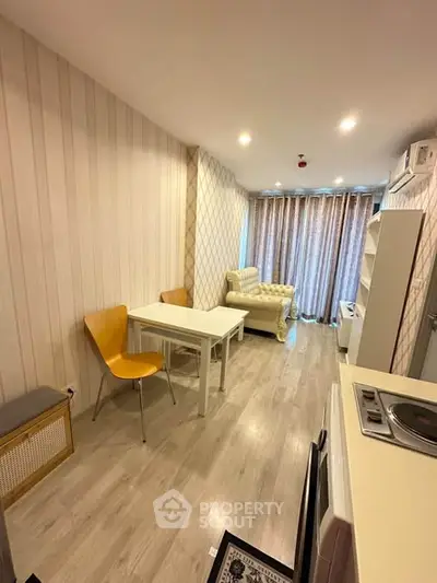 Modern living room with stylish decor and open layout, featuring cozy seating and dining area.