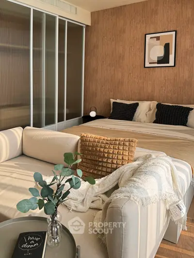 Cozy bedroom with stylish decor and comfortable seating area, perfect for relaxation and modern living.