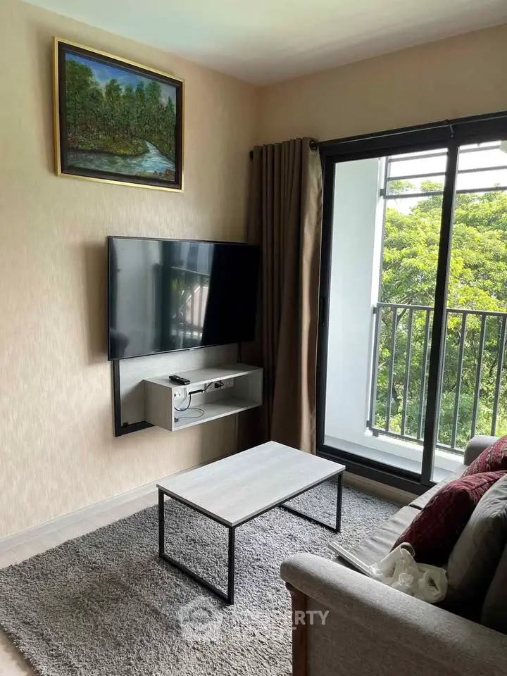 Modern living room with wall-mounted TV and balcony view
