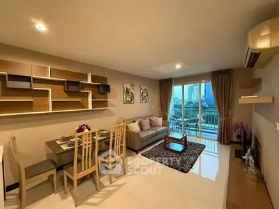 Modern living room with dining area and city view balcony in stylish apartment.
