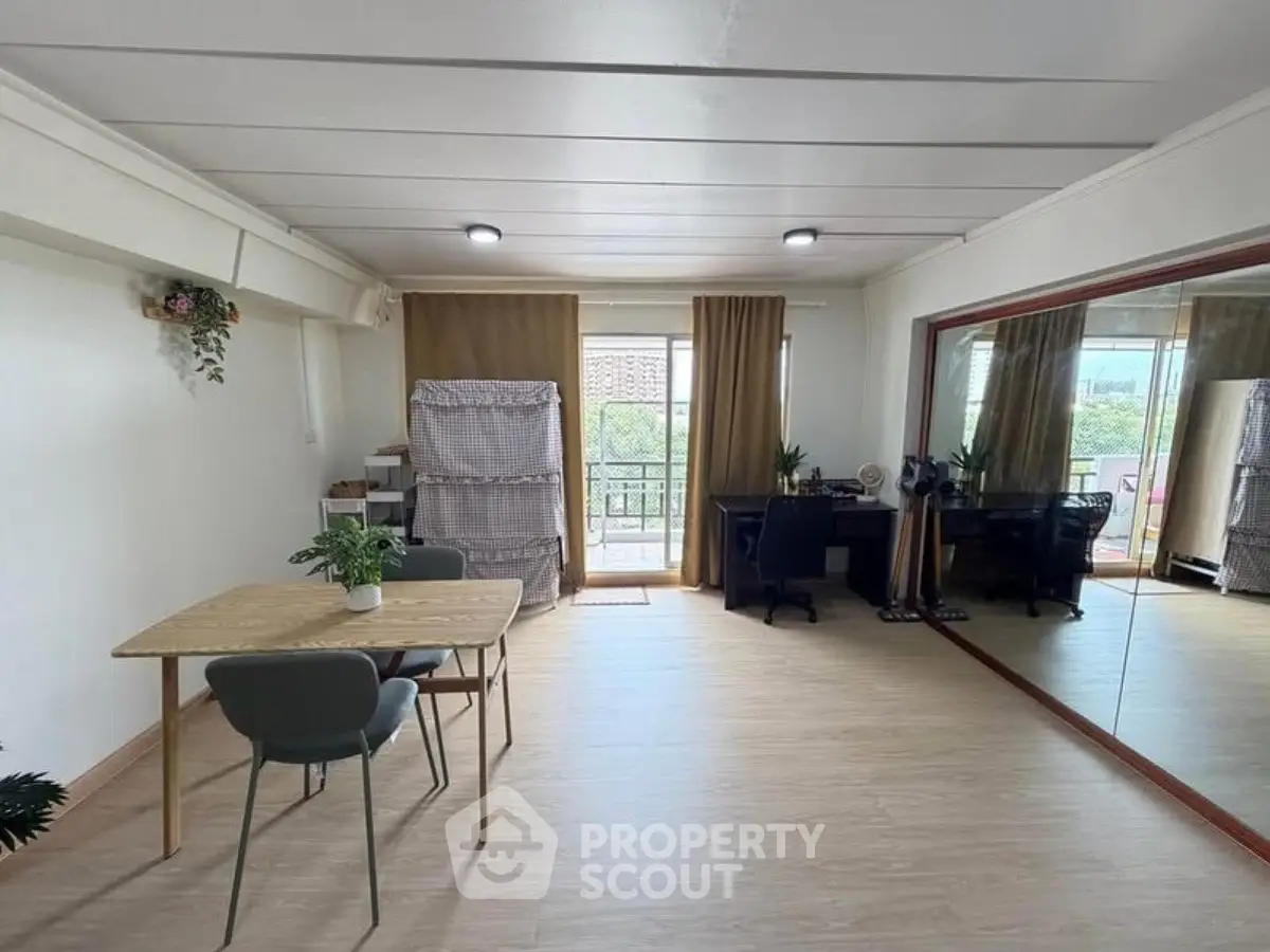 Spacious living room with balcony access and modern decor