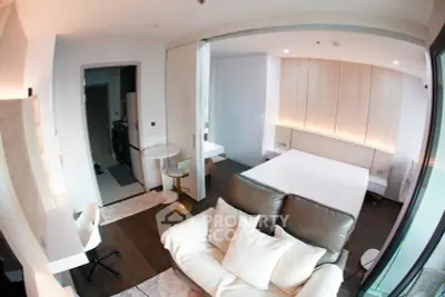 Modern studio apartment with open layout, featuring cozy living area and stylish bedroom design.
