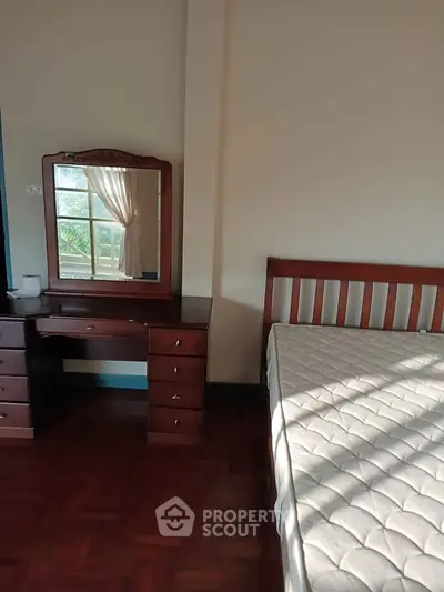 Cozy bedroom with wooden furniture and natural light