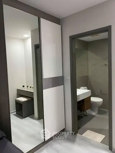 Modern apartment interior with sleek bathroom and stylish wardrobe