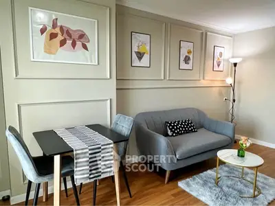 Stylish living room with modern decor, featuring a cozy sofa, elegant dining set, and chic wall art.