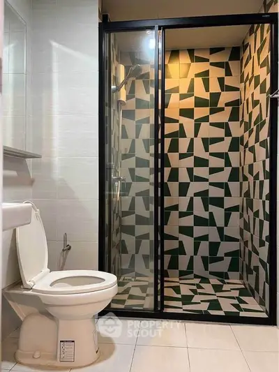 Modern bathroom with geometric tile shower and sleek fixtures